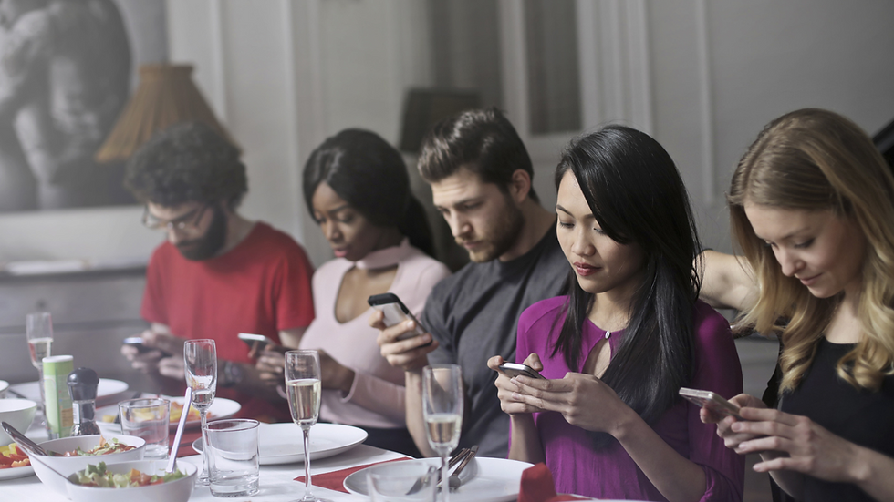 diverse people using mobile phone in front of food