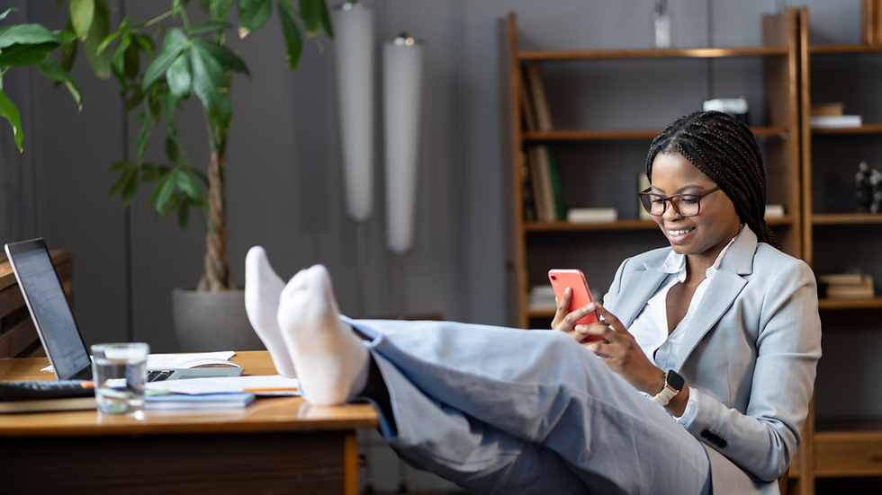 black woman sitting on her desk procrastinating.