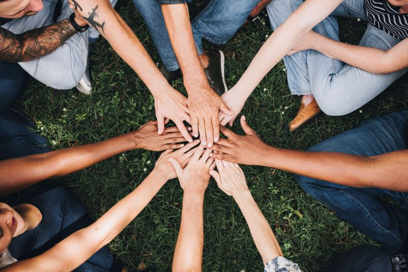 Diverse people stacking their hands